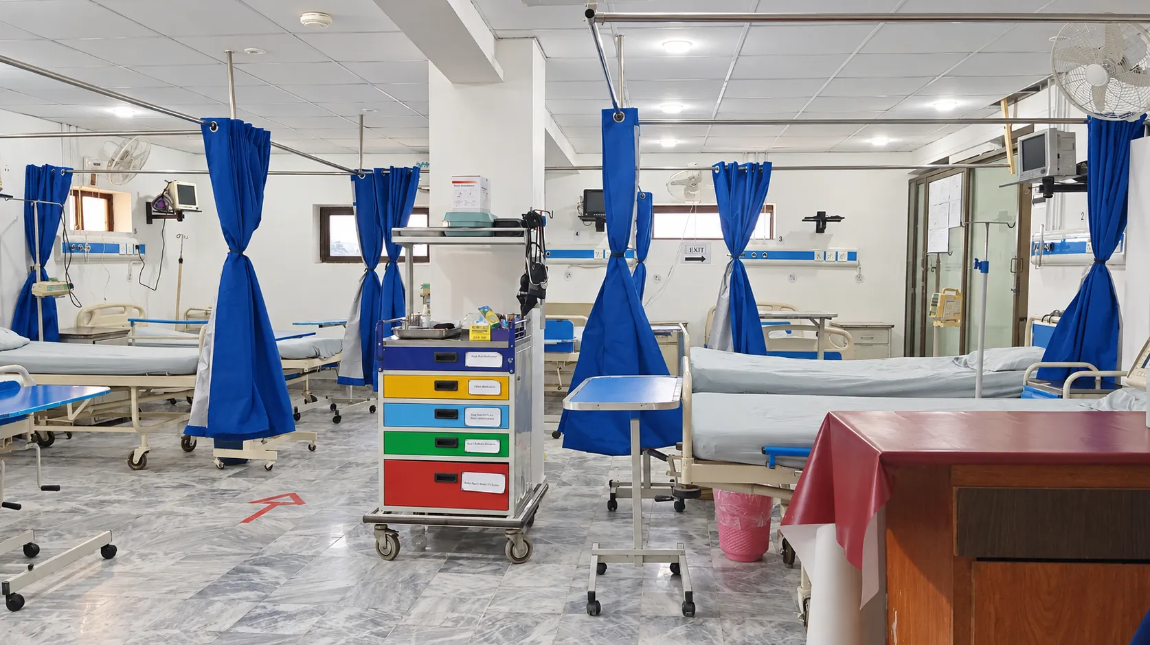 ICU beds, monitors and blue privacy curtains at Sarwet Anver Medical Complex